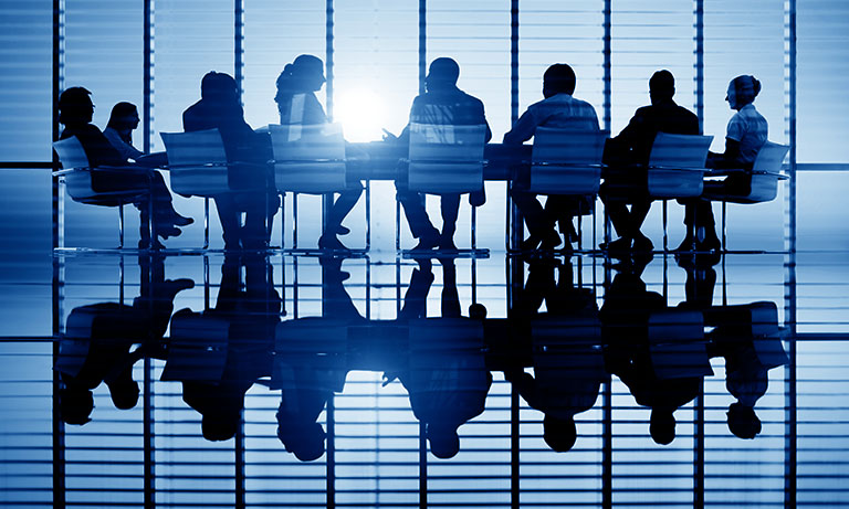 transactional liability insurance. meeting room with silhouettes of people against sun coming in window